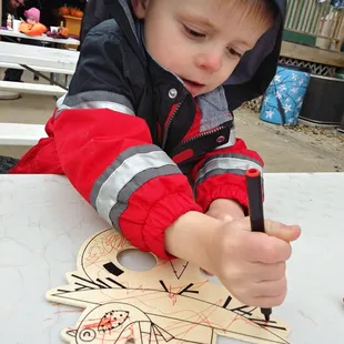 a young boy playing with a toy airplane