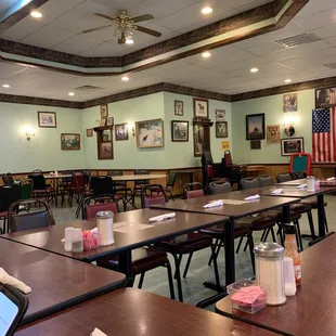 a large dining room with tables and chairs