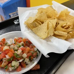 a plate of chips and a bowl of salsa