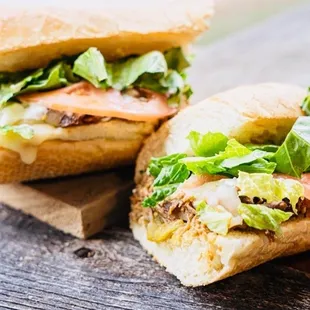 two sandwiches on a cutting board