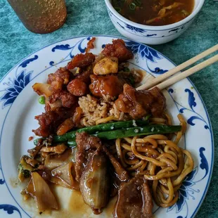 a plate of noodles with meat and vegetables