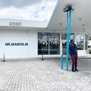 a man standing in front of a diner