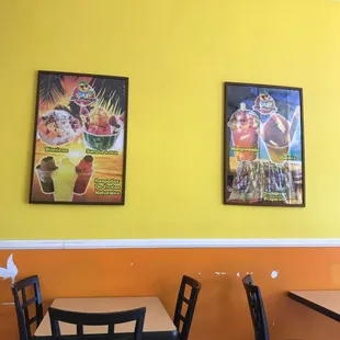a couple of paintings on the wall of a restaurant