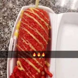 a plastic container with a large piece of food in it