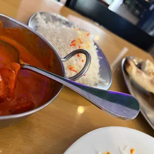 a bowl of masala and a plate of rice