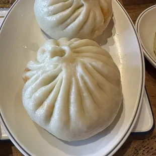 three steamed buns on a plate