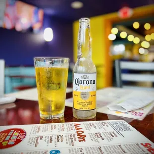 a bottle of coronano and a glass of beer