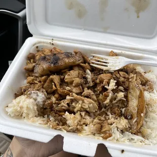 a takeout box of rice and meat