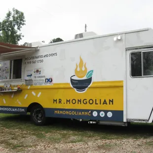 a food truck parked in a field