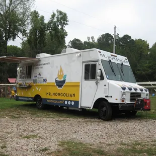 a food truck parked in a field