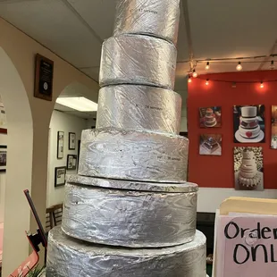 This is the cake size tower that shows what size cake you can get and how many hungry cake fans it will feed. Cake display is  silver foil
