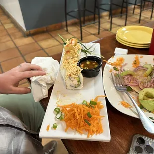  person sitting at a table with a plate of food