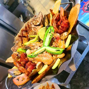 Carnaval De Mariscos.  Shrimp, whole fried tilapia, bacon wrapped shrimp, clams &amp; fish.