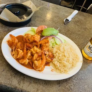 a plate of food and a bottle of beer