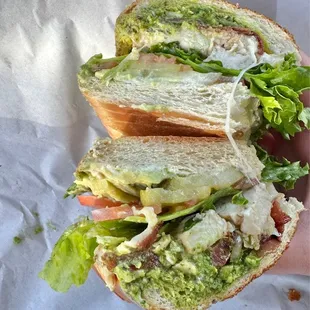 a hand holding a sandwich