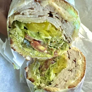 TURKEY with the works plus pesto, sprouts and pepper jack cheese on Dutch crunch toasted.