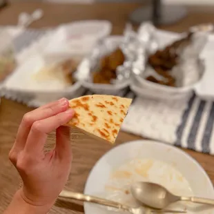 a person holding a piece of bread