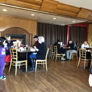 people sitting at tables in a restaurant