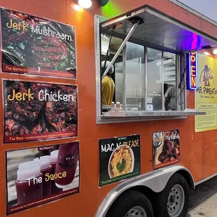a food truck with posters on it