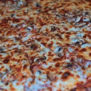 a pizza with mushrooms and cheese