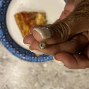 Metal rivet in pizza