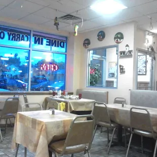 a dining area with tables and chairs
