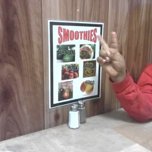 a man sitting at a table with a menu in front of him