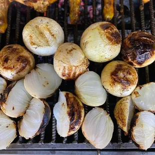 onions and meat on a grill