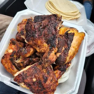 chicken and tortillas in a styrofoam container