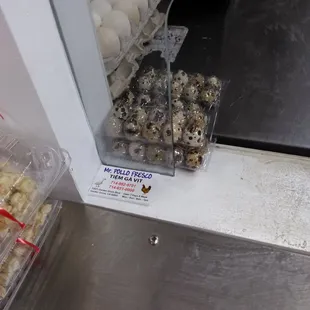 a display of eggs in plastic containers