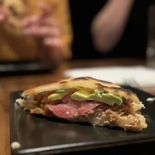 a sandwich with meat and avocado