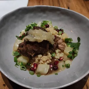 Braised lamb, simmered onion, green onions,cilantro, pomegranate and Yukon?