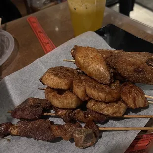 a pile of skewered meat