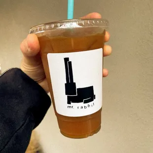 a hand holding a cup of coffee