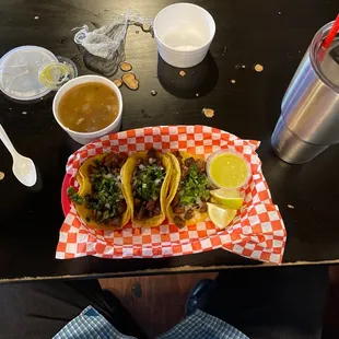 a plate of tacos and a drink