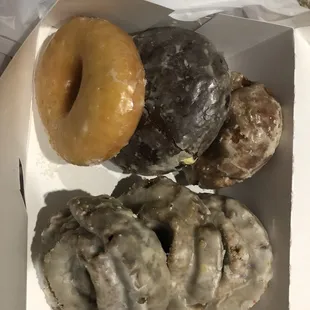 From top left to bottom right; plain glazed, chocolate shell with creme, pumpkin spice glazed, devils food glazed, blueberry glazed