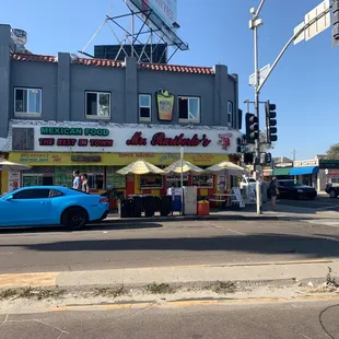 a blue car parked in front of it