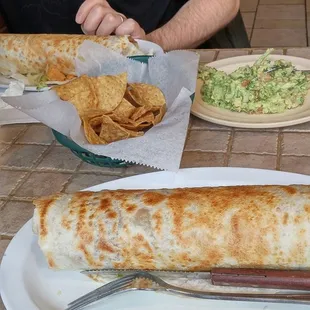 a burrito and chips on a plate