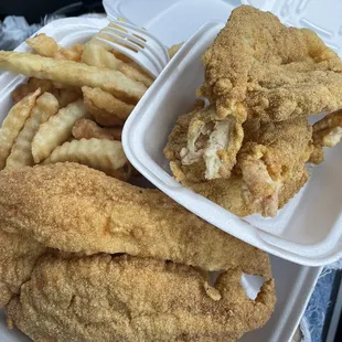 fried fish and french fries in a styrofoam container