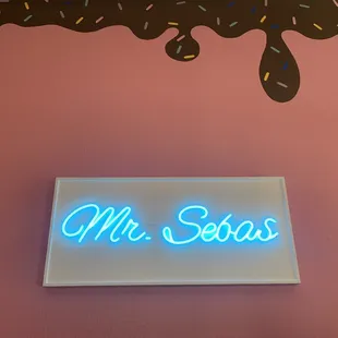 a neon sign with sprinkles