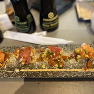 Towering sushi poke - assorted fish &amp; crab on a won ton chip with ponzu, spicy Mayo, and eel sauce