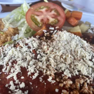 a plate of enchiladas and rice