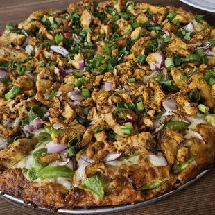 Half butter chicken and half chicken tikka masala pizza
