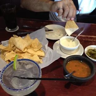 Queso blanco with chile,mouthwatering warm salsa,tortilla chips &amp; to complete this picture,a margarita on the rocks with salt!