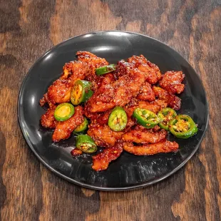 a plate of fried chicken with jalapenos