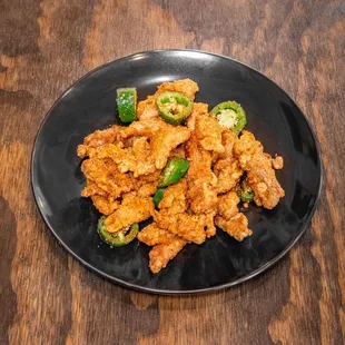 a plate of fried chicken with jalapenos