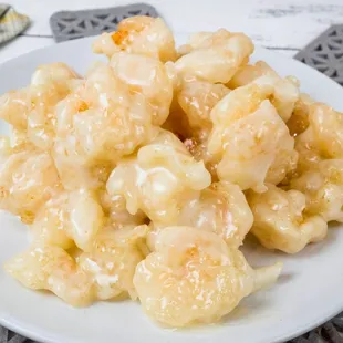 a white plate of shrimp