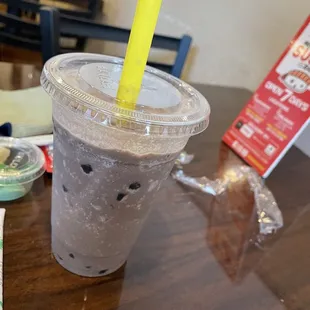 a plastic cup with a straw