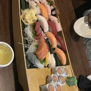 Sushi boat! Spicy tuna roll, shrimp tempura roll and 12 sashimi and 12 nigiri&apos;s.