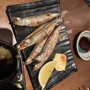 grilled fish on a black plate